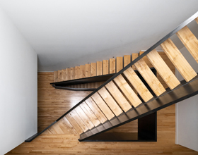 Sculptural staircase becomes focal point in unconventional Montreal house