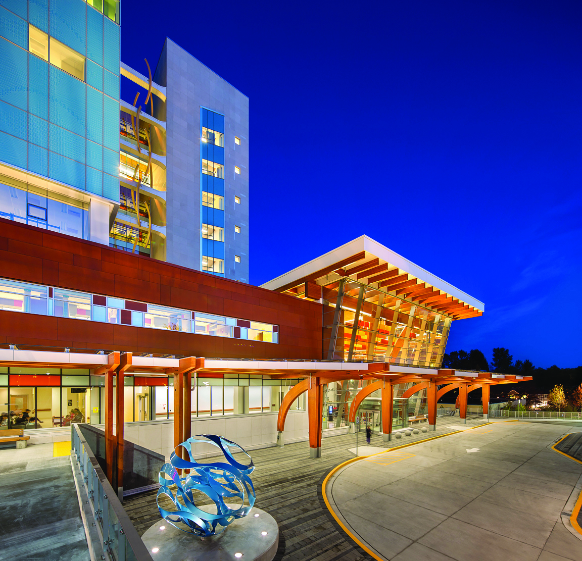 The curved pieces in the tower’s center—designed to evoke DNA strands— were constructed from cedar glulam material. The typical connection employs a through-bolted knife plate and a screwed back plate. Epoxy is injected to fi ll the space around the knife plate.