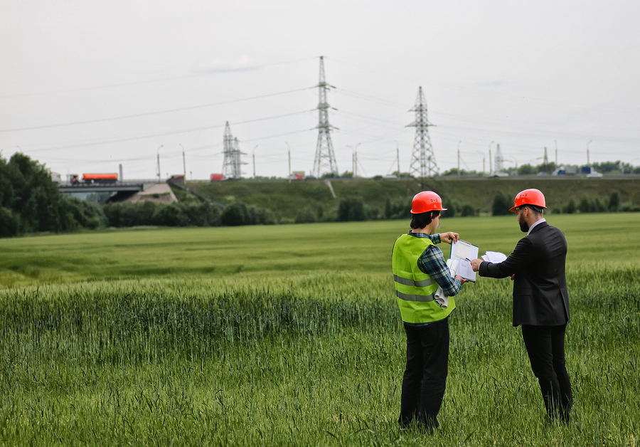 man with cottage plan construction in green field Construction Canada
