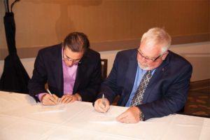 Building Systems Design (BSD) CEO Chris Anderson and CSC president David Boyle, CTR, officially sign the deal that will see the two jointly provide the Canadian National Master Specification (NMS) via new and improved website, www.specmarket.com.