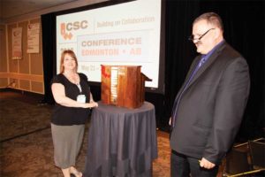 Brenda Thompson of the Winnipeg Chapter accepts the Lloyd Boddy Chapter of the Year Award from CSC executive director Nick Franjic, CAE.