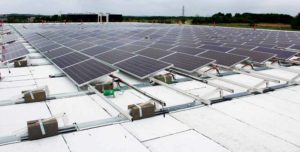 A flat roof with torch-down membrane. Black slipsheets have been placed under the ballasted racking for extra protection.