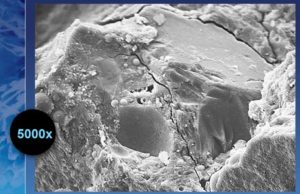 Figure 1: Scanning electron microscope (SEM) view of micro-cracks found in concrete, which allows water and water vapor to flow through it. The permeability of concrete can eventually lead to the corrosion of reinforcing steel and the deterioration of concrete itself.