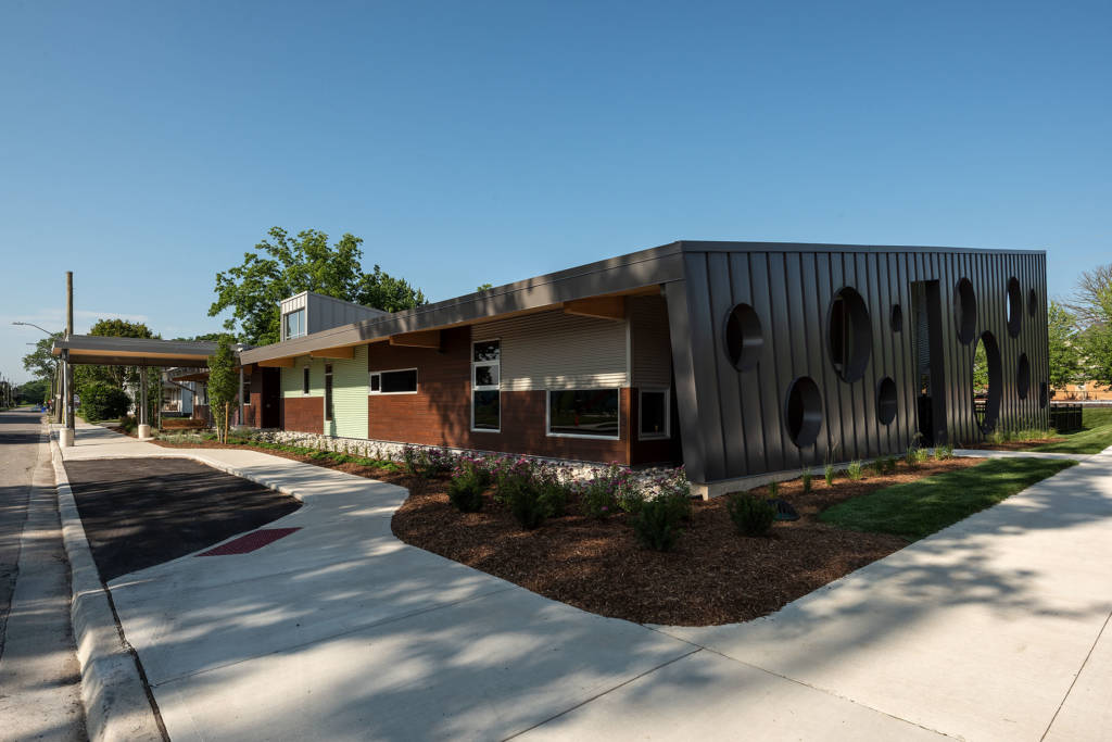 The metal roof extends out in eaves at the sides of the facility. The swiss cheese pattern is evident on one end of the facility.