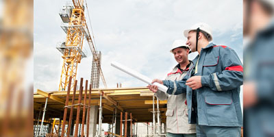 construction workers discussing something in front of a site