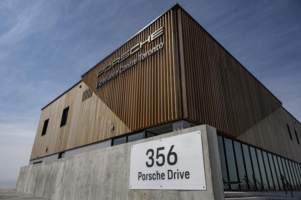 Exterior view of the Porsche Experience Centre Toronto building with wooden paneling and the address sign reading '356 Porsche Drive'.