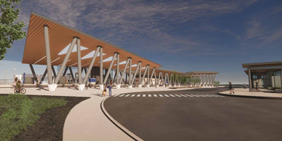 Modern transportation hub with a wooden canopy, striking supports, and pedestrian access, set against a clear blue sky.