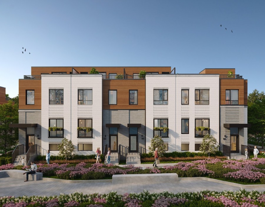 Modern townhomes with wood and white brick facades, surrounded by blooming flowers and people enjoying the neighborhood under a clear blue sky.