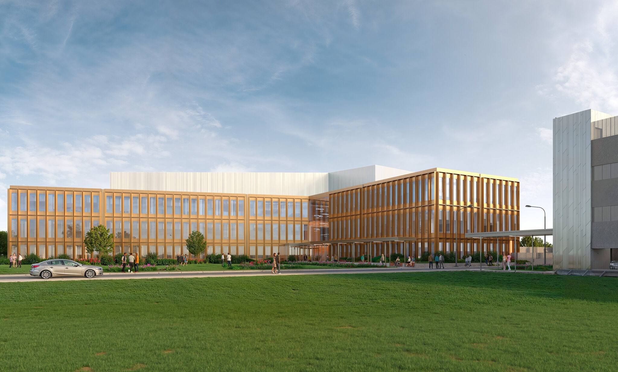 Modern building with wooden accents and large windows, surrounded by greenery and people enjoying the outdoor space. Clear blue sky above.