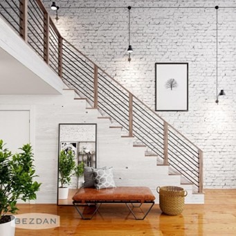 A modern interior with a wooden staircase, brick wall, stylish seating, a mirror, plants, and pendant lighting creating a cozy ambiance.