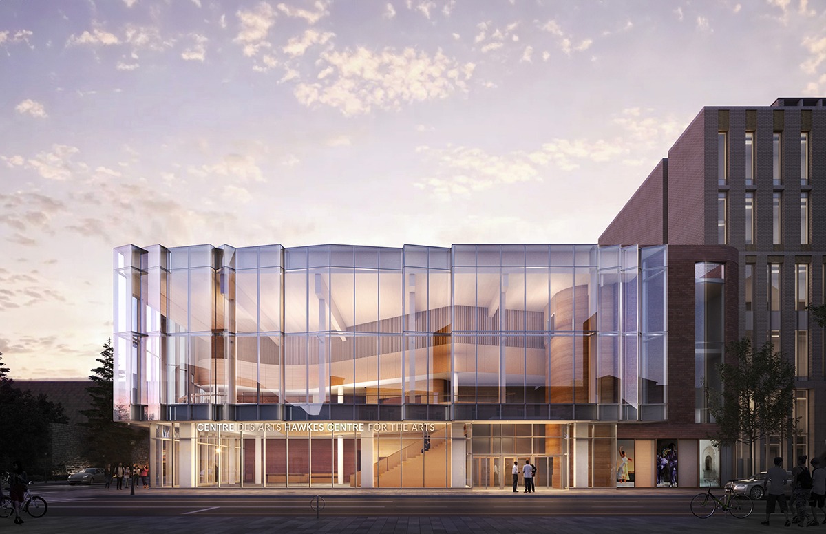 Modern architectural design of the Hawkes Centre for the Arts, featuring large glass panels and a warm entrance, set against a twilight sky.