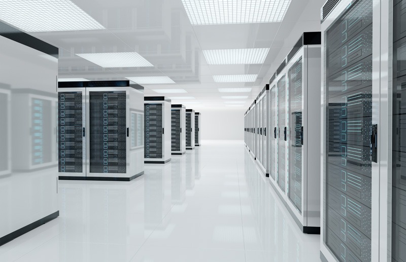 Bright, modern server room with rows of sleek, silver server racks on a reflective floor. The atmosphere is clean, organized, and high-tech.