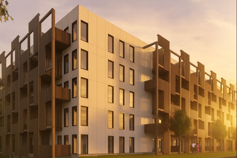 Modern multi-story apartment building with a dark wooden facade on one side and a white smooth facade on the other, bathed in golden light at sunset.