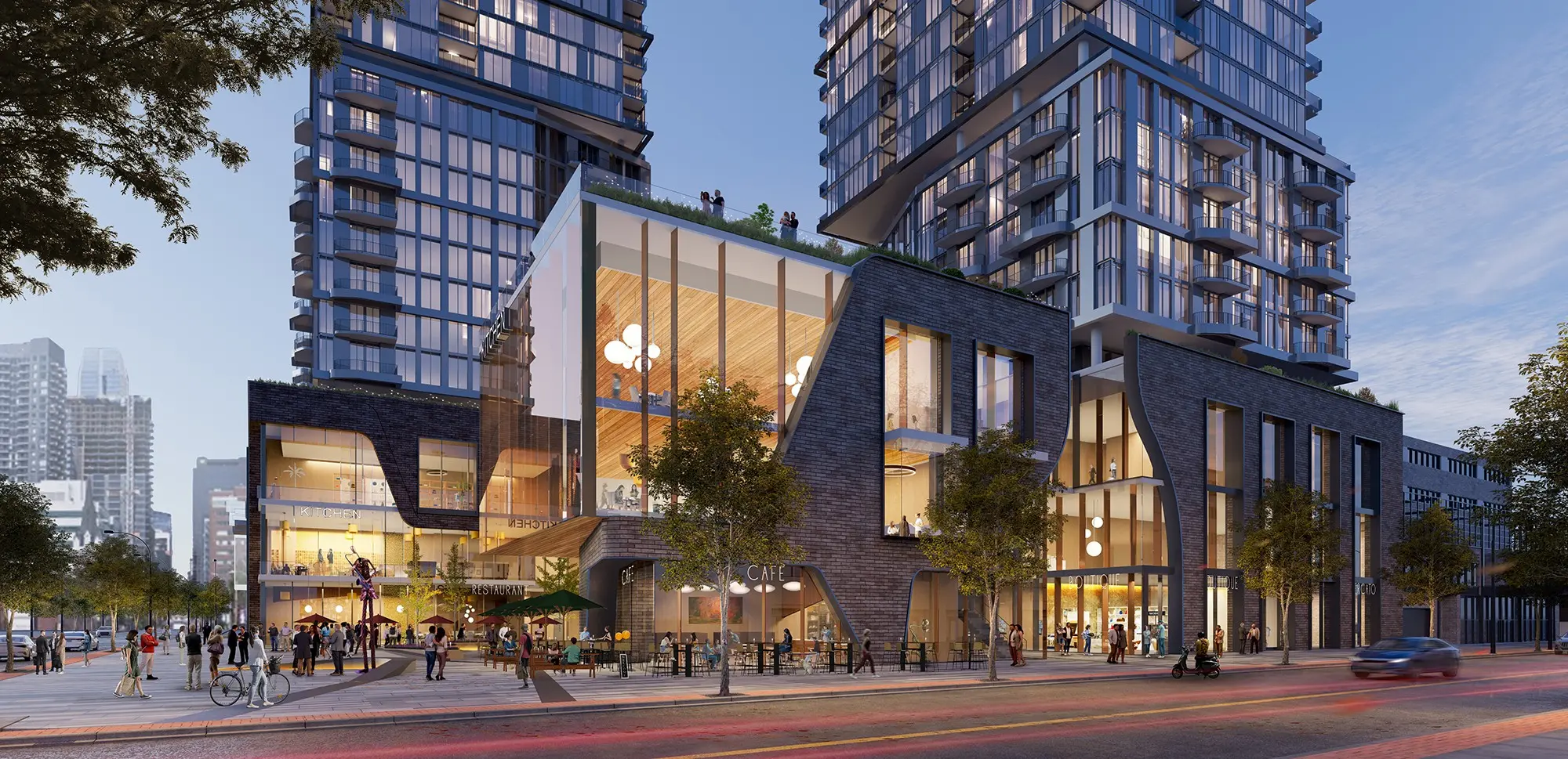 Modern architectural complex featuring glass and brick buildings with a plaza, people dining and walking, and a skyline backdrop.