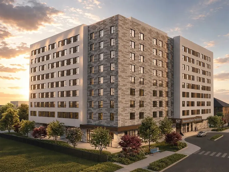 Modern multi-story Basswood Student Residence building with brick-patterned walls, rows of windows, and landscaped grounds at sunset.