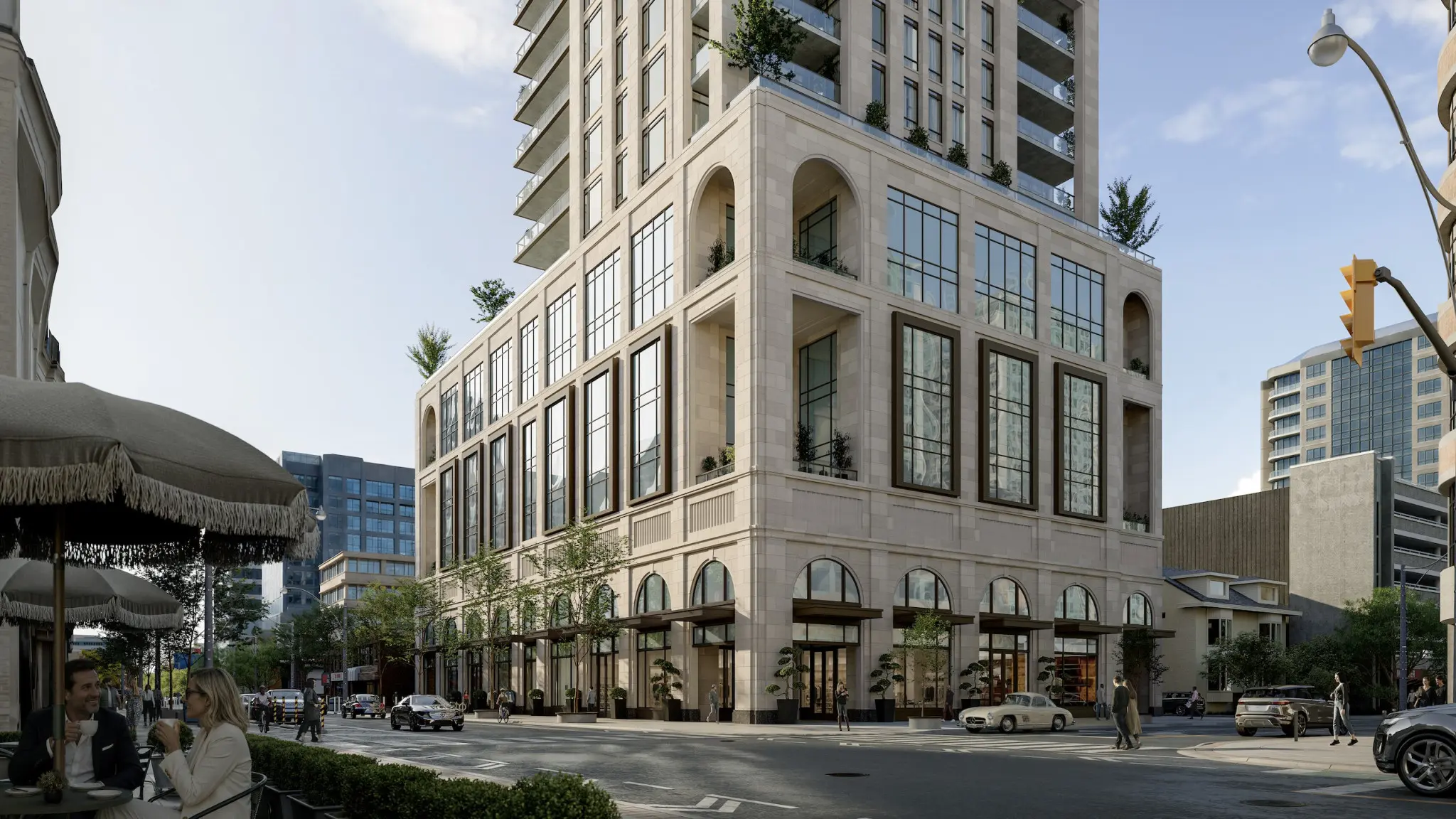 Urban street scene with a grand multi-story stone building, café seating, pedestrians, cars, and surrounding high-rises.