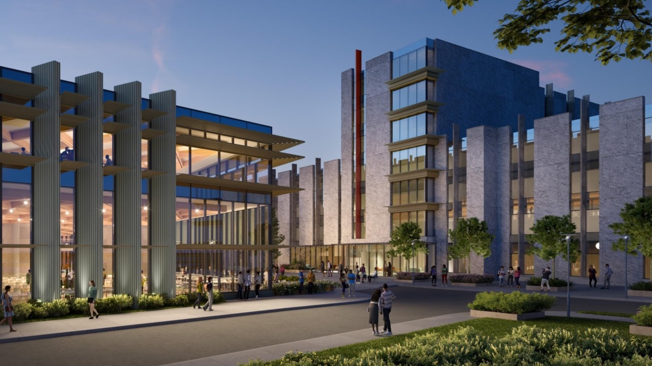 Modern illuminated campus complex with glass façades, gray stone buildings, landscaped plaza, and pedestrians at dusk.